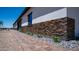 Up-close detail of home's attractive stacked stone accents, desert plantings, and paver walkway at 10910 N Thunderbird Rd, Maricopa, AZ 85139