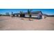 A single-story home with a modern design, stone accents, an attached garage, and desert landscaping at 10910 N Thunderbird Rd, Maricopa, AZ 85139