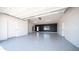 Spacious and immaculate garage featuring epoxy flooring and ample lighting, perfect for car enthusiasts or storage at 10910 N Thunderbird Rd, Maricopa, AZ 85139