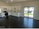 Open kitchen with white cabinets and sliding glass doors to the patio at 10910 N Thunderbird Rd, Maricopa, AZ 85139
