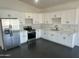 Bright kitchen featuring stainless steel appliances and white cabinetry at 10910 N Thunderbird Rd, Maricopa, AZ 85139