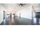 Spacious open-concept living area with sleek flooring, abundant natural light, and modern kitchen at 10910 N Thunderbird Rd, Maricopa, AZ 85139