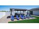 Inviting outdoor seating area with modern lounge chairs and bar, perfect for entertaining guests in style at 10910 N Thunderbird Rd, Maricopa, AZ 85139