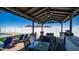 Inviting outdoor entertainment area with a covered seating, dining area, a grill, and mountain views at 10910 N Thunderbird Rd, Maricopa, AZ 85139