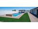 Stunning backyard pool area with a built-in bar, lounge chairs, and well manicured turf perfect for outdoor entertaining at 10910 N Thunderbird Rd, Maricopa, AZ 85139