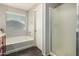 This bathroom includes a soaking tub and a walk-in shower at 12041 W Melinda Ln, Sun City, AZ 85373