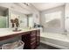 Bright bathroom featuring a large mirror, soaking tub, and plenty of counter space at 12041 W Melinda Ln, Sun City, AZ 85373