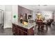 Living area with view of kitchen/dining, perfect for Gathering meals and entertaining guests at 12041 W Melinda Ln, Sun City, AZ 85373