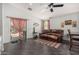 Living room featuring a ceiling fan, leather sofa, and access to the outdoor patio at 12041 W Melinda Ln, Sun City, AZ 85373