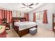 Comfortable bedroom with a large bed, bedside table and unique wallpaper at 12041 W Melinda Ln, Sun City, AZ 85373