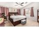 Comfortable bedroom with a large bed, bedside table and unique wallpaper at 12041 W Melinda Ln, Sun City, AZ 85373