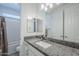 Bathroom features a gray granite countertop, white cabinetry, and a shower and bathtub combo at 12048 E Chevelon Trl, Gold Canyon, AZ 85118