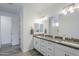 Bathroom with granite countertops, dual sinks, and a large well lit mirror at 12048 E Chevelon Trl, Gold Canyon, AZ 85118