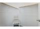 Walk-in closet with neutral walls, rack storage, and a charming chair at 12048 E Chevelon Trl, Gold Canyon, AZ 85118