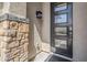 Modern front door with decorative glass panels and stone accents on the home's exterior at 12048 E Chevelon Trl, Gold Canyon, AZ 85118