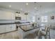 Bright kitchen with white cabinets, granite countertops, a large island with pendant lighting, and stainless steel appliances at 12048 E Chevelon Trl, Gold Canyon, AZ 85118