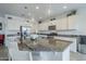 Modern kitchen with granite countertops, stainless steel appliances, and pendant lighting at 12048 E Chevelon Trl, Gold Canyon, AZ 85118