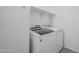 Bright laundry room features a new washer and dryer and shelving for additional storage at 12048 E Chevelon Trl, Gold Canyon, AZ 85118