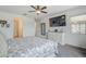 Comfortable main bedroom with a ceiling fan, TV, and stylish furnishings at 12048 E Chevelon Trl, Gold Canyon, AZ 85118