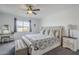 Serene main bedroom with a plush upholstered bed, neutral decor, and a ceiling fan at 12048 E Chevelon Trl, Gold Canyon, AZ 85118