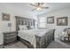 Spacious main bedroom features a decorative wood-style bed frame, ceiling fan, and neutral walls at 12048 E Chevelon Trl, Gold Canyon, AZ 85118