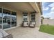 Covered outdoor patio seating area with neutral decor and tiled flooring at 12048 E Chevelon Trl, Gold Canyon, AZ 85118