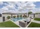 Backyard pool with a fire pit, patio seating, and meticulous landscaping at 12048 E Chevelon Trl, Gold Canyon, AZ 85118