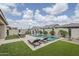 Backyard oasis with a sparkling pool, lounge chairs, and manicured landscaping at 12048 E Chevelon Trl, Gold Canyon, AZ 85118