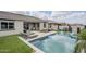 Inviting backyard pool area with lounge chairs, outdoor seating, and lush landscaping at 12048 E Chevelon Trl, Gold Canyon, AZ 85118