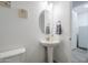 Powder room features a pedestal sink, decorative mirror and clean white walls at 12048 E Chevelon Trl, Gold Canyon, AZ 85118