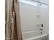 A clean, bright shower and tub combo features neutral walls and a floral patterned shower curtain at 12048 E Chevelon Trl, Gold Canyon, AZ 85118