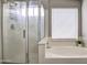 Modern bathroom with a separate shower and soaking tub with a large window at 12543 W Roanoke Ave, Avondale, AZ 85392