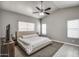 Spacious bedroom with a large ceiling fan, neutral tones, and large windows at 12543 W Roanoke Ave, Avondale, AZ 85392