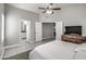 Bedroom with carpet and tile flooring, a ceiling fan, and ensuite bathroom and closet at 12543 W Roanoke Ave, Avondale, AZ 85392
