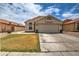 Charming single-story home featuring a desert landscape, tile roof, and a two-car garage at 12543 W Roanoke Ave, Avondale, AZ 85392