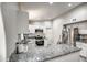 Updated kitchen with granite countertops, stainless steel appliances, and white cabinetry at 12543 W Roanoke Ave, Avondale, AZ 85392
