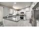 Modern kitchen featuring granite counters, stainless steel appliances, and white cabinets at 12543 W Roanoke Ave, Avondale, AZ 85392