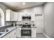 Bright kitchen featuring white cabinets, granite countertops, and stainless steel appliances at 12543 W Roanoke Ave, Avondale, AZ 85392