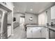 Modern kitchen with eat in dining, stainless steel refrigerator, and sleek white cabinets at 12543 W Roanoke Ave, Avondale, AZ 85392