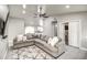 Bright living room features tile flooring, vaulted ceilings, and a ceiling fan at 12543 W Roanoke Ave, Avondale, AZ 85392