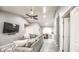 Open living room boasts neutral paint, vaulted ceiling, tile flooring, and a ceiling fan at 12543 W Roanoke Ave, Avondale, AZ 85392