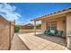 Charming covered patio with tiled flooring and comfortable seating, perfect for outdoor relaxation and entertaining at 12543 W Roanoke Ave, Avondale, AZ 85392