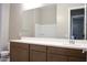 Bathroom featuring a large mirror, a single sink vanity with modern fixtures, and a view of the shower and toilet at 1255 N Arizona Ave # 1216, Chandler, AZ 85225