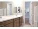 A bathroom vanity featuring double sinks and a large mirror with a view to the closet at 1255 N Arizona Ave # 1216, Chandler, AZ 85225