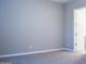 This empty bedroom features neutral walls and plush carpeting, offering a blank canvas for personalization at 1255 N Arizona Ave # 1216, Chandler, AZ 85225