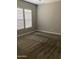 Cozy bedroom features plush carpeting, a ceiling fan, and natural light from a large window at 1255 N Arizona Ave # 1216, Chandler, AZ 85225