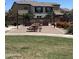 Community picnic area with grilling stations and picnic tables surrounded by landscaped grounds and green grass at 1255 N Arizona Ave # 1216, Chandler, AZ 85225