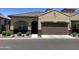 Inviting home exterior showcasing a tile roof, a two car garage, and well-manicured landscaping at 1255 N Arizona Ave # 1216, Chandler, AZ 85225