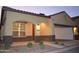 A charming home exterior with an arched entrance, well-maintained landscaping, and a two car garage at 1255 N Arizona Ave # 1216, Chandler, AZ 85225