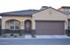 Inviting single-story home showcasing a well-maintained front yard, stylish brown garage door and desert landscaping at 1255 N Arizona Ave # 1216, Chandler, AZ 85225